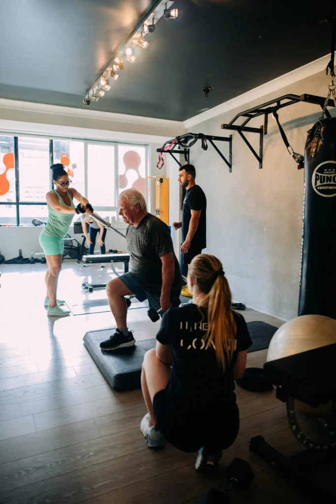 Clients train with coaches inside a FitnessLab studio.